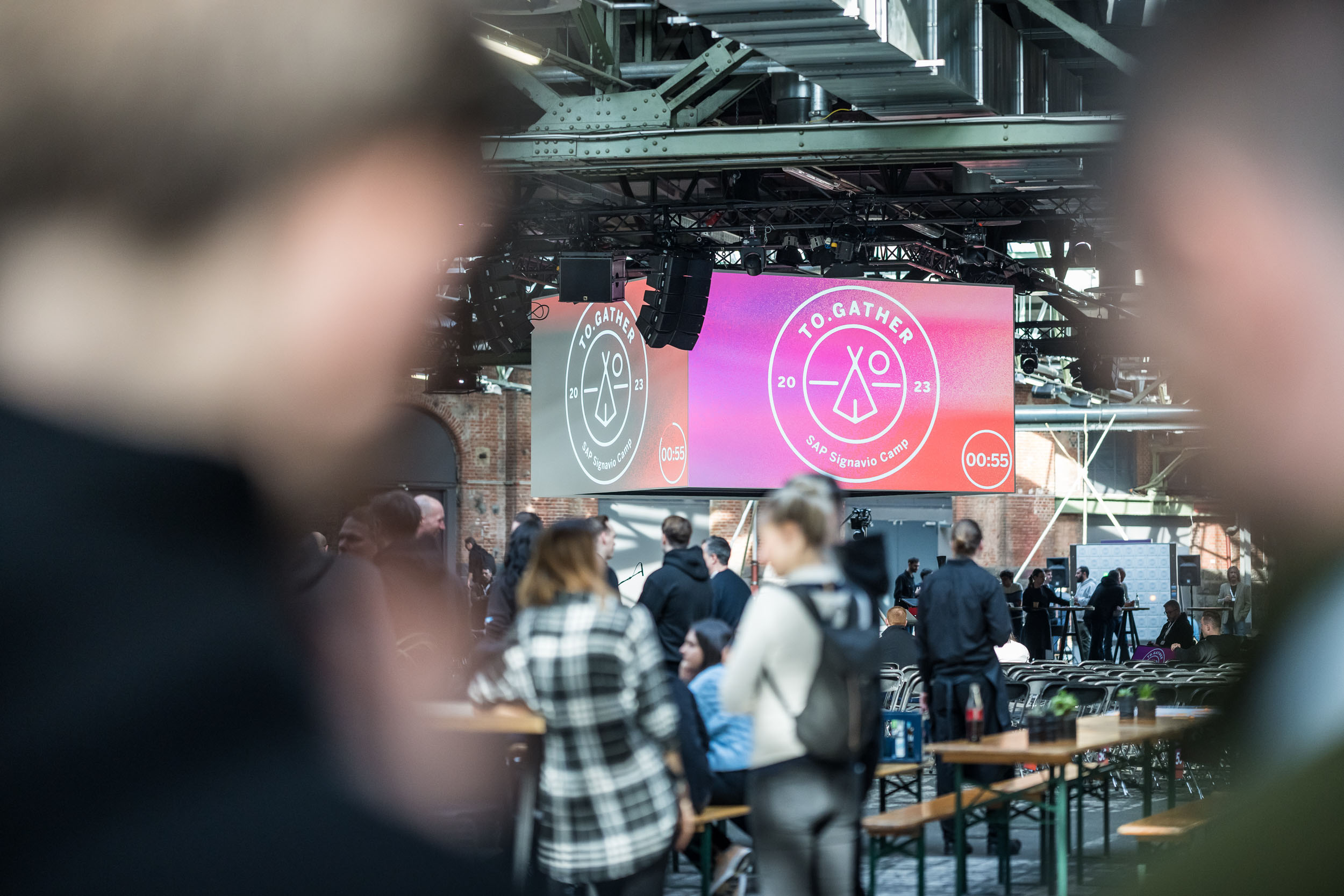 Ein Foto von der Hauptbühne mit einem Projektionswürfel und dem Branding der Veranstaltung.